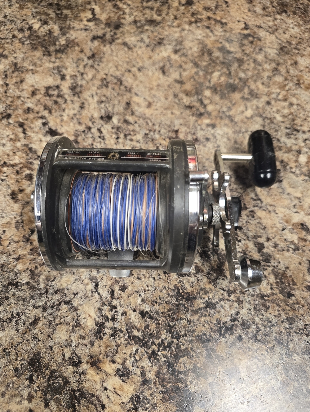 Vintage Fishing Reel with Blue Line
